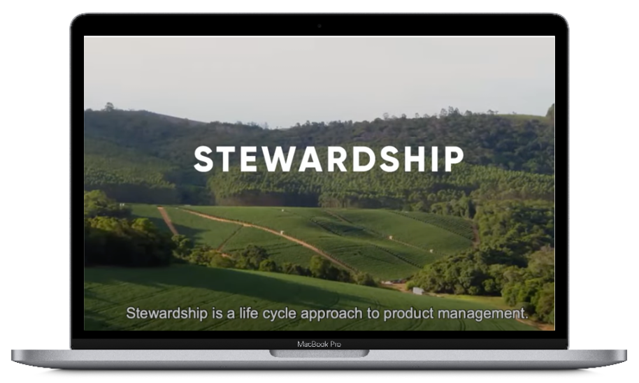 Laptop screen displaying an agricultural landscape with the word 'Stewardship' and the subtitle 'Stewardship is a life cycle approach to product management.
