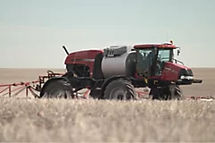 Red sprayer in field