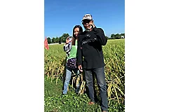 husband and wife doing the Corteva "C" hand sign