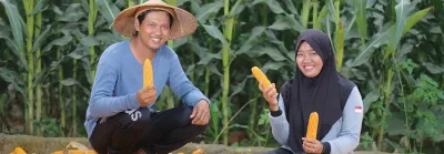 Two farmers holding lettuce